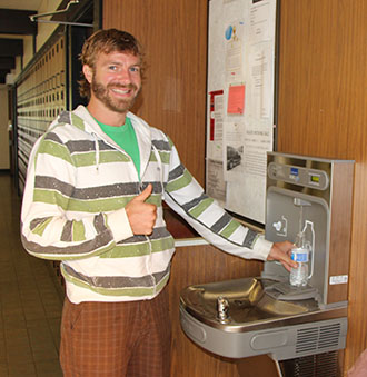 David Henry refills his waterbottle in an effort to reduce waste.