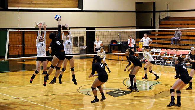 Kathryn Epler(4) and Kelsey Warren (8) attempt to block a hit as Danae Perkey, Elysha Lang, and Jocelyn Vallencia cover the court.