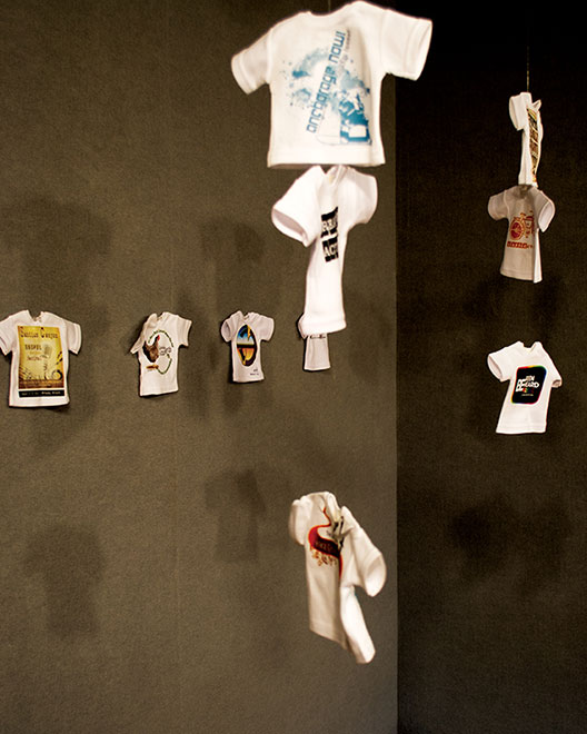 Stephenie LaFleur looks to “spark a dialogue amoung strangers regarding a variety of social issues” with her art entitled “T-shirt.” Each small t-shirt contained images of social issue. She also notes t-shirts are one on the most discarded items in the USA and the most wanted items in third world countries.